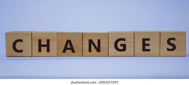 CHANGES symbol. Copy space. Concept word CHANGES on wooden blocks with blue background. Business and financial concept. - Powered by Shutterstock