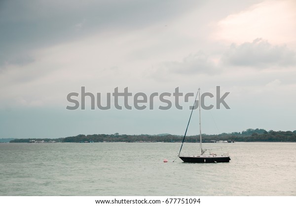 Changi, Singapore - April 30, 2017: Small\
private yacht anchored along the Changi Boardwalk. The boardwalk\
span a 2.2 km consist a jogging track, fitness corners, rest areas\
and car park for\
visitors.