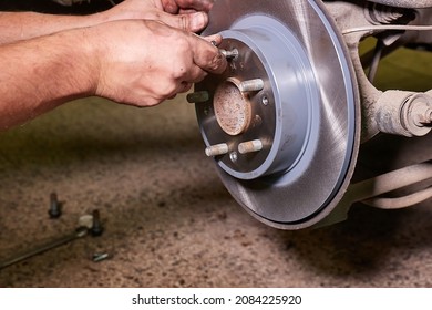 Changing Brake Rotor Disc On A Car In The Garage