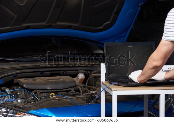 Changing car engine setting. Tuning car engine on\
computer 