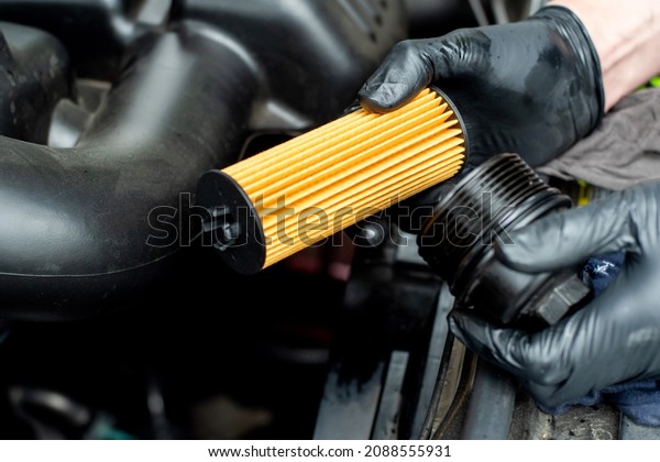 Changing car oil filter. DIY change engine motor\
oil. At home vehicle maintenance. Oil Filter replacement. New Oil\
filter