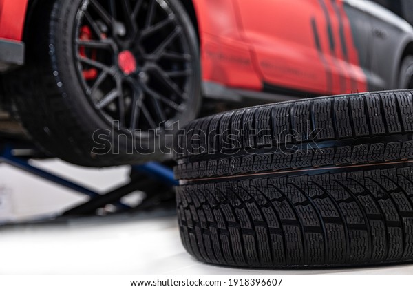 Changing\
car tire and wheel in the car mechanical\
service