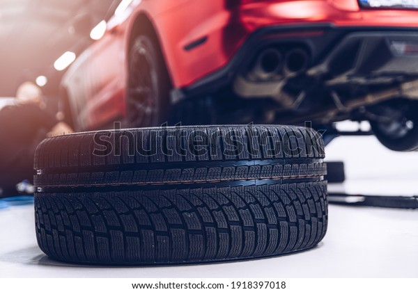 Changing\
car tire and wheel in the car mechanical\
service
