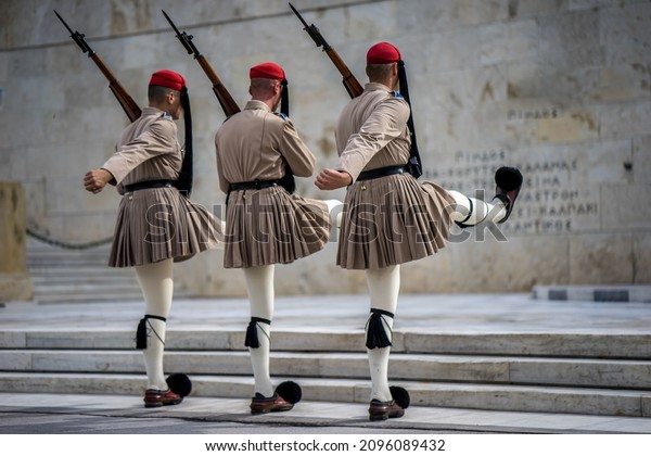 changing of the guard in Athens, three soldiers\
with rifles