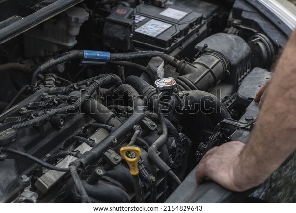 Changing the oil in the car, the process of\
checking the oil in the engine of the car\
