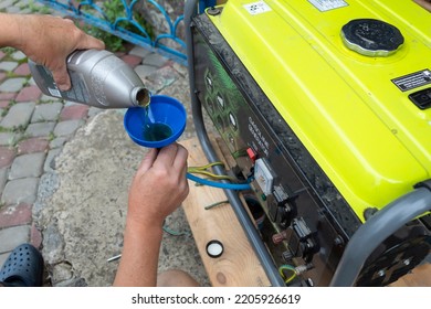 Changing the oil on a portable generator.  - Shutterstock ID 2205926619