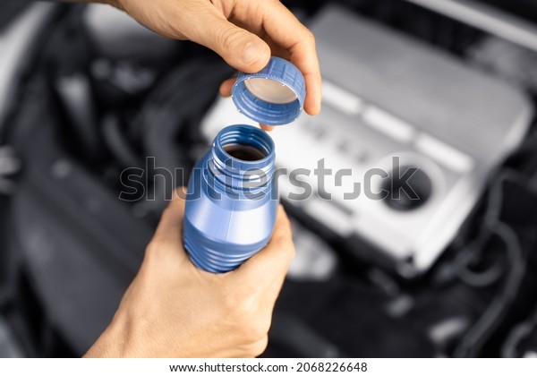 Changing oil, putting\
new engine oil in car 