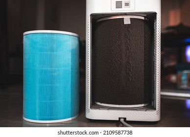 Changing The Old, Used And Dirty Air Purifier Filter With Pollutants And Dust Particles With A New HEPA Filter For Clean And Fresh Indoor Air. Air Filter Replacement.