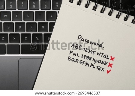 Changing password. Notebook with correct and incorrect passwords and laptop, top view
