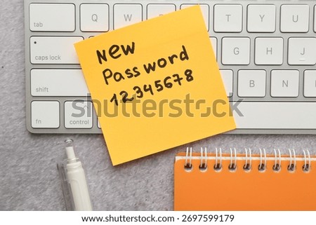 Changing password. Sticky note with new passcode, computer keyboard and stationery on grey table, flat lay