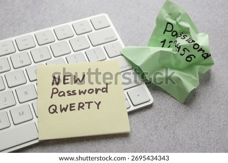 Changing password. Sticky notes with old and new passcodes near computer keyboard on grey table, closeup