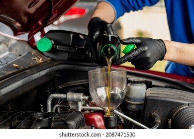 Changing Replacement Car Oil With Plastic Bottle. DIY Change Engine Motor Oil. At Home Vehicle Maintenance. Garage Mechanic Concept