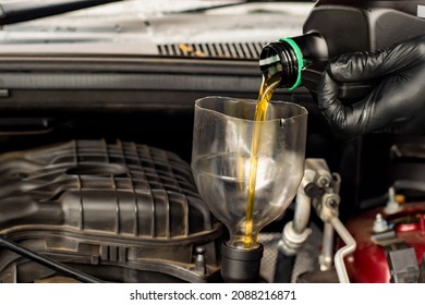 Changing Replacement Car Oil With Plastic Bottle. DIY Change Engine Motor Oil. At Home Vehicle Maintenance. Garage Mechanic Concept