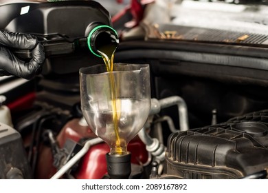 Changing Replacement Car Oil With Plastic Bottle. DIY Change Engine Motor Oil. At Home Vehicle Maintenance. Garage Mechanic Concept