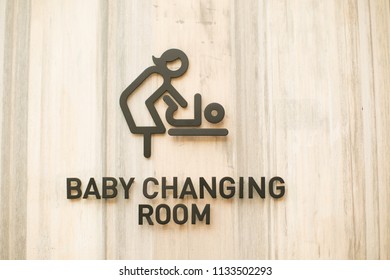 Changing Room For Baby After Take A Bath. Mother Can Use This Room To Do Everything With Kid. It’s Comfortable Service By Department Store. Sign On Wood Background. Brown Color Wooden Symbol.