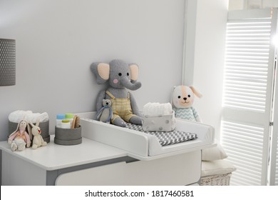 Changing tray and pad on chest of drawers in baby room. Interior design - Powered by Shutterstock