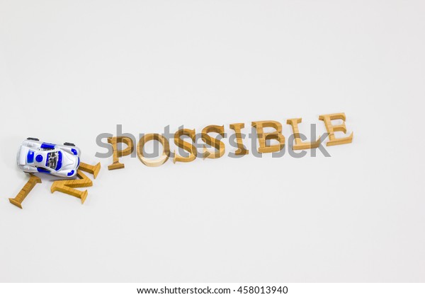 Changing the word impossible to\
possible with crashing car toy. Concept of positive\
attitude