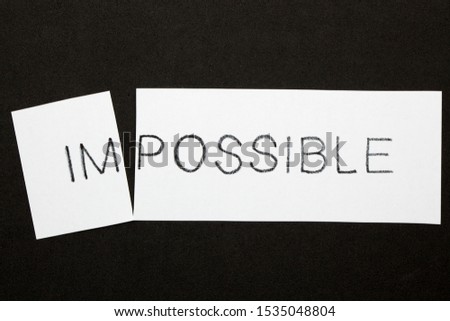 Changing word impossible transformed to possible on a white sheet. Business concept.