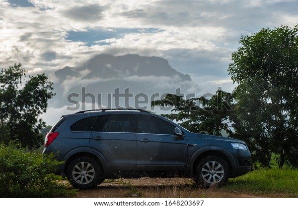 Changmai,Thailand - October 20 2018:\
Private car test drive, Gray color Chevrolet Captiva Photo on\
country road at Changdao\
Mountain,Thailand