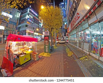 Changwon, South Korea - November 25, 2013: A Typical Asian City Downtown At Night. Nights Are Generally Busy, With Open Businesses - Such As Restaurants And Coffee Shops - And Bright Lights. 