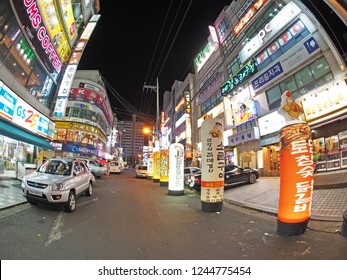 Changwon, South Korea - November 25, 2013: A Typical Asian City Downtown At Night. Nights Are Generally Busy, With Open Businesses - Such As Restaurants And Coffee Shops - And Bright Lights. 