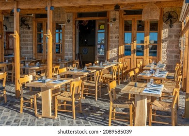 Chania, Greece - May 21, 2021: View Of An Empty Tavern In The Harbor Of Chania City On Crete Island, Greece.