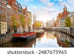 Channel in Amsterdam Netherlands. Houses and river Amstel. Famous european landmark. Old city landscape during sunset