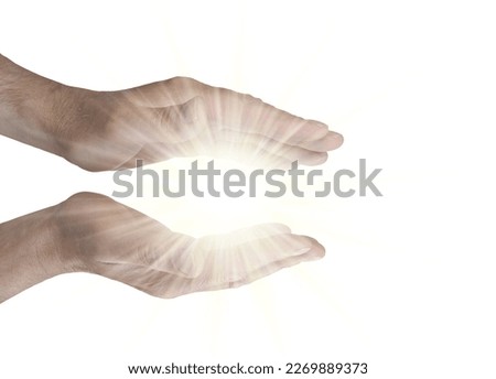 Channeling Pure Healing Energy - male parallel hands isolated on white background with a bright glowing energy orb between 
