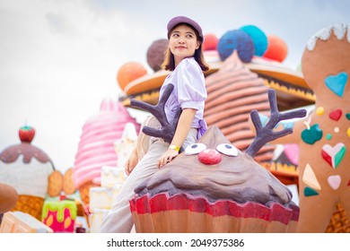 Chanthaburi, Thailand,September 29, 2021: Portrait of Asian woman with purple hat is happy and relaxed in candyland