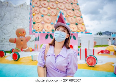 Chanthaburi, Thailand,September 29, 2021: Portrait of Asian woman with purple hat is happy and relaxed in candyland