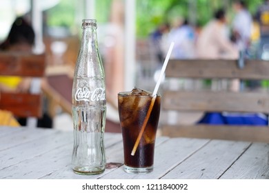 CHANTHABURI,THAILAND-October 24,2018: Empty bottle of  Coca Cola  and Coca Cola in the glass on the table.