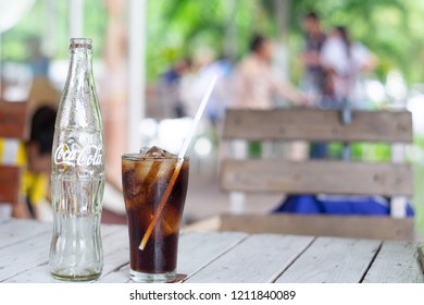 CHANTHABURI,THAILAND-October 24,2018: Empty Coca Cola bottle and Coca Cola in the glass.