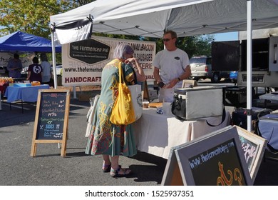 Chantilly, VA / USA - September 19, 2019: Older Caucasian Woman Buying Groceries At The Chantilly Community Foodworks Farmers Market