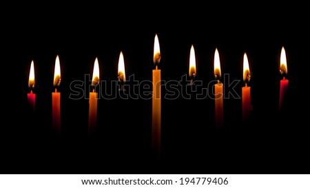 Many lighted candles in a church