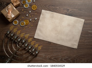 Chanukah Gifts Shiny Coins And Candies, Menorah On A Wooden Table. Top View