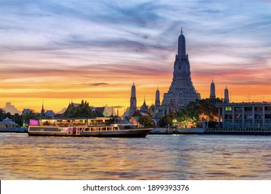 Chao Phraya River Cruise Boat with Temple of the Dawn, Wat Arun, at Sunset in Background, Horizontal