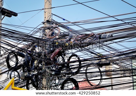 The chaos of cables and wires on every street in Bangkok, Thailand.  