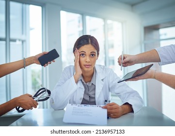 Its Too Chaotic To Cope. Portrait Of A Young Female Doctor Looking Stressed Out In A Demanding Work Environment.