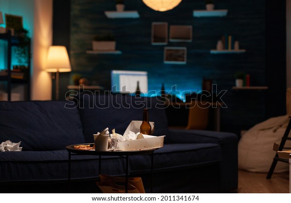 Chaotic empty living room of depressed person with\
scattered food mess, messy table. Unorganized house apartment of\
lonely woman with sever depression having garbage, rubbish with no\
people in