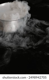 A chaotic eruption of dry ice explodes in a frenzy of swirling white mist. The force of the blast sends shards of ice flying in every direction, creating a mesmerizing and dangerous spectacle. 