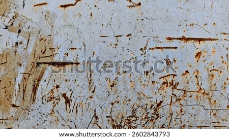 A chaotic pattern of rust and paint streaks across a textured surface, creating an abstract and distressed visual. The interplay of colors and textures evokes a sense of age and decay.