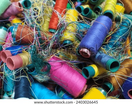 Chaotic pile of colorful sewing threads stock photo.