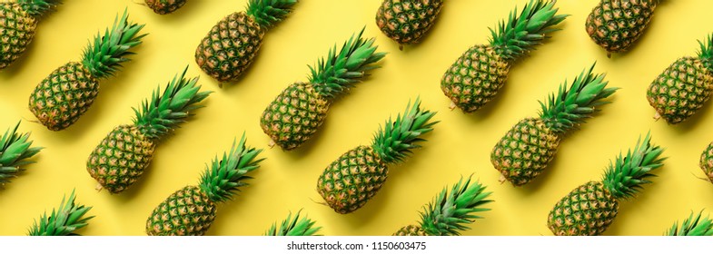 Chaotic pineapple pattern for minimal style. Top View. Pop art design, creative concept. Copy Space. Banner. Fresh pineapples on yellow background