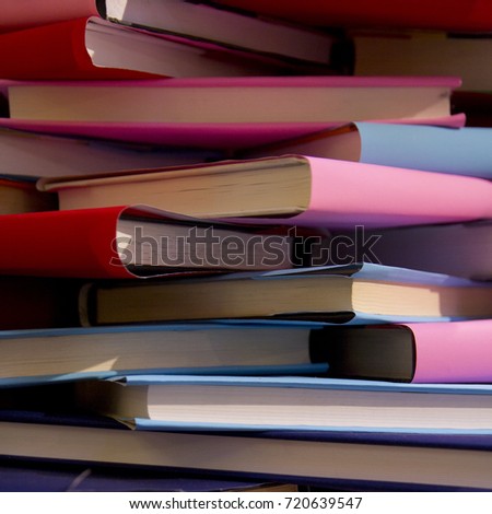 chaotic stack of old books background, selective focus