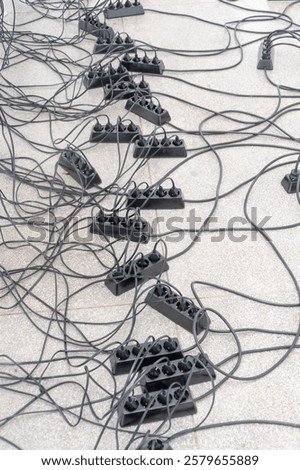 Chaotically arranged electrical cables and splitters.