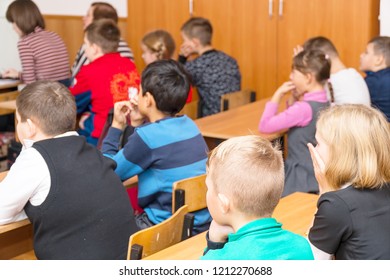 CHAPAEVSK, SAMARA REGION, RUSSIA - OCTOBER 24, 2018: School kids in the classroom sitting at their desks and listen to the teacher in classroom from back