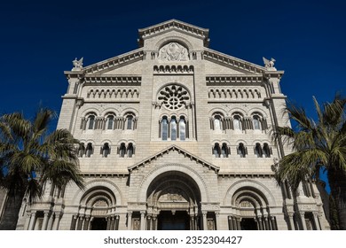 Chapel of the Visitation church in the old town of Monaco with palm trees and blue sky
