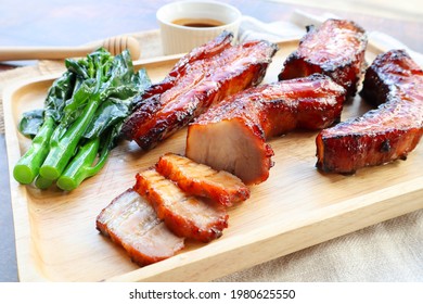 Char Siu - Honey barbecue roast pork on wood tray of wood table - Chinese style grilled pork at close up view