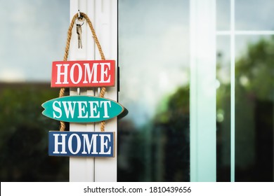 
Character, home sweet home, hang on front door of house. Real estate agent offer house, property insurance and security, affordable housing concepts