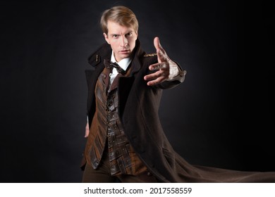 character of steampunk story, young attractive man in an elegant long coat, adventurer makes an epic gesture. intelligent gentleman in Victorian style. Vintage retro suit, young attractive man